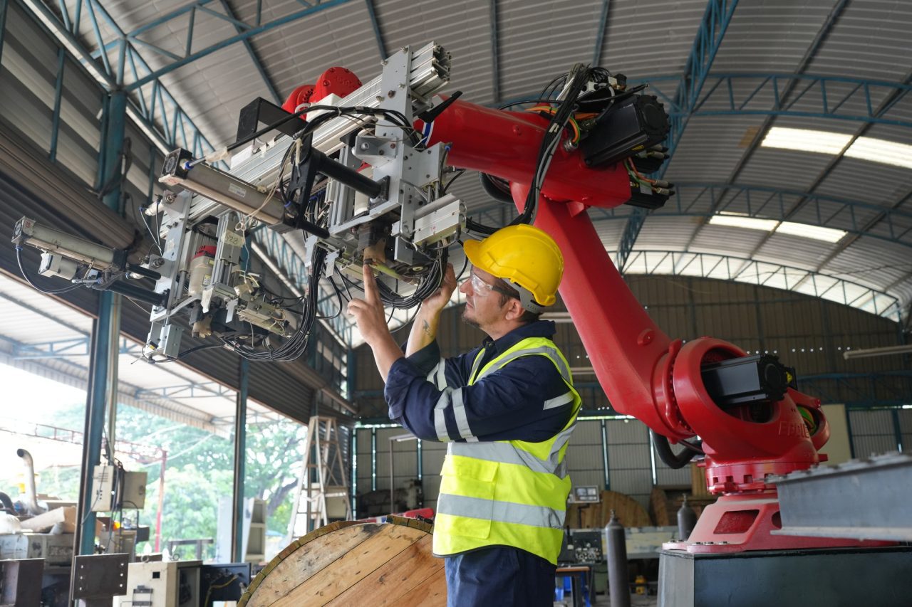 technology-and-industrial-processes-industrial-engineer-working-on-automated-robotic-arm.jpg